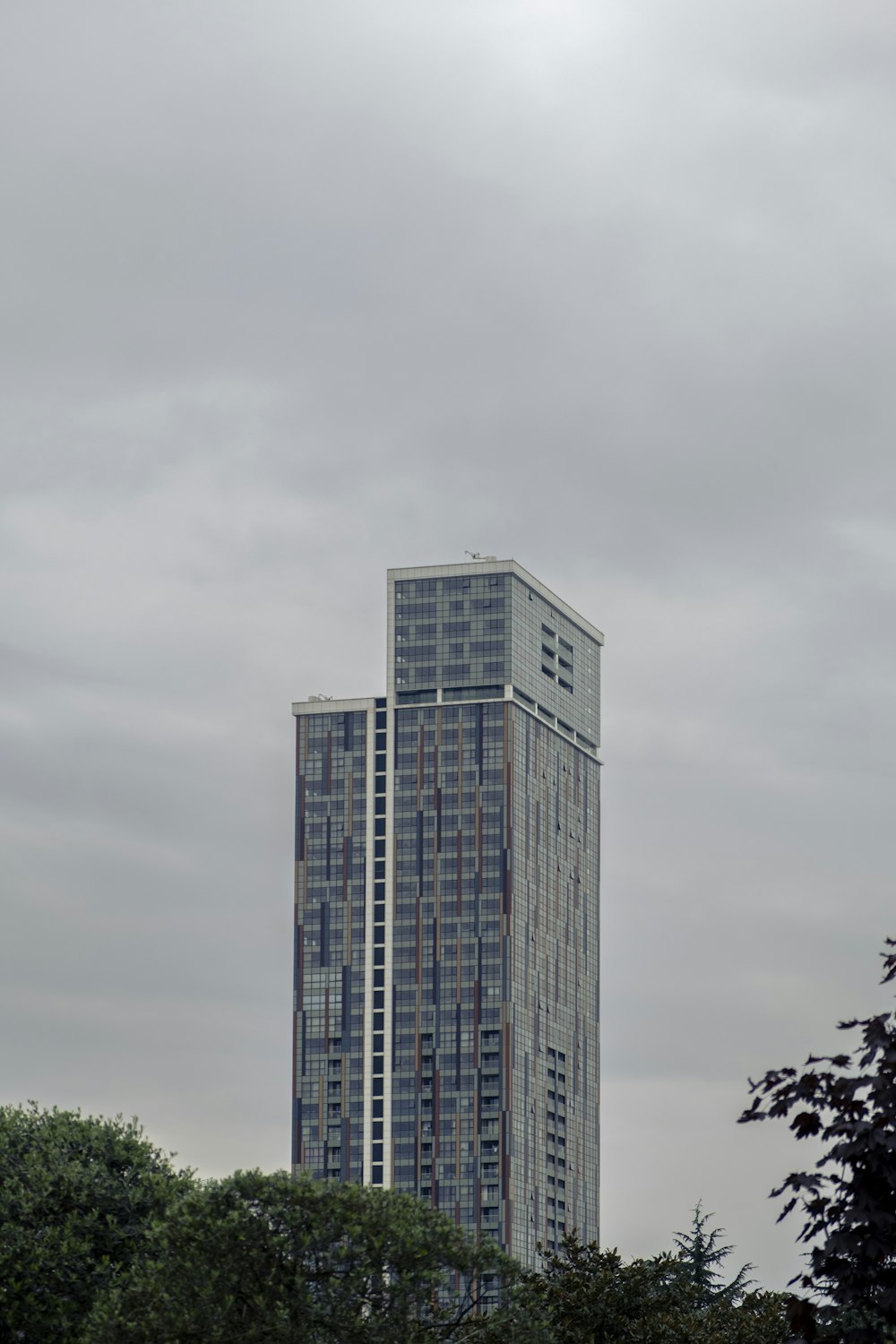 a tall building with trees in the front