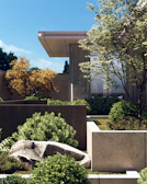 a large building with a fence and trees in the front