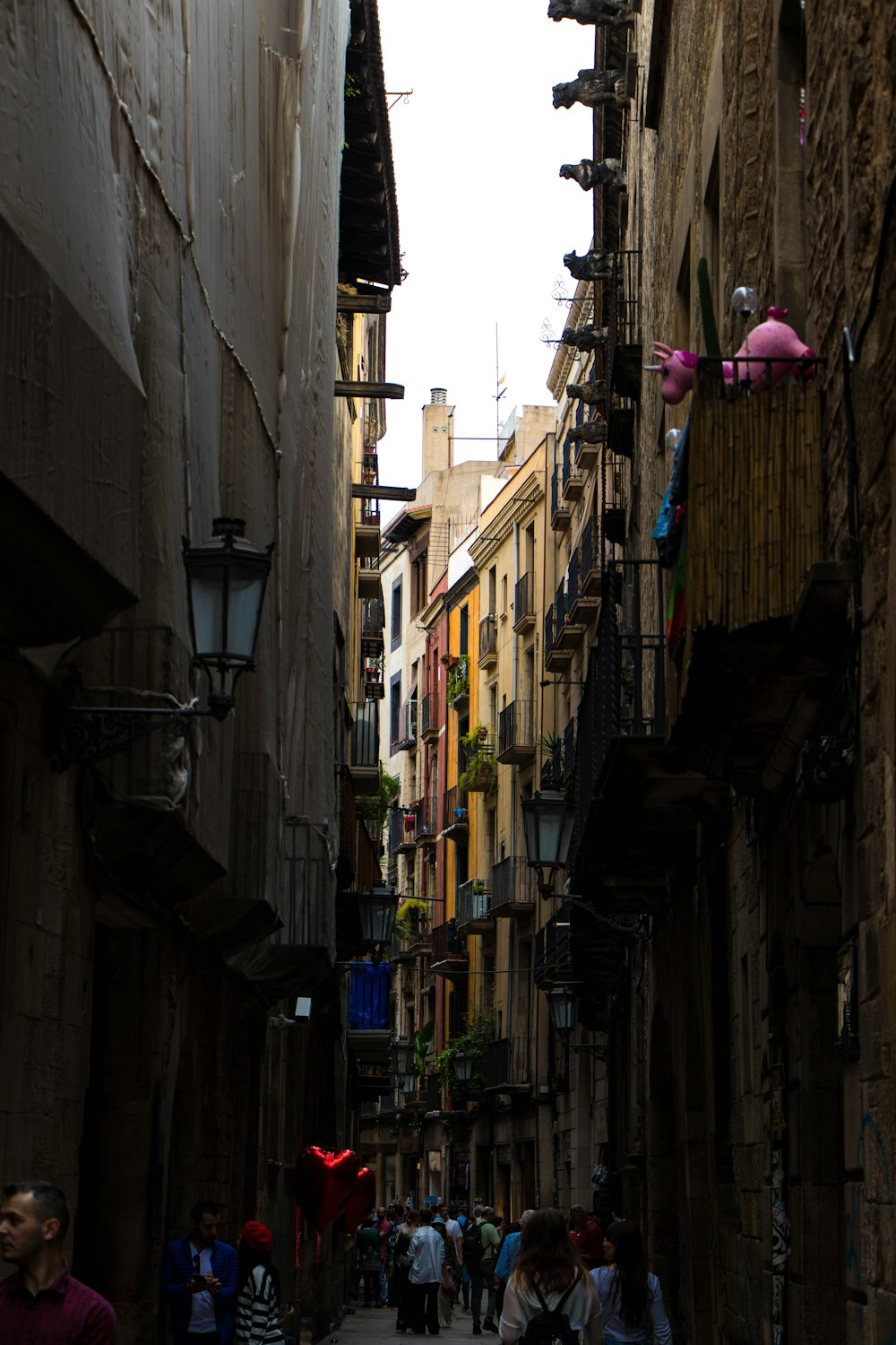 a narrow street with people walking