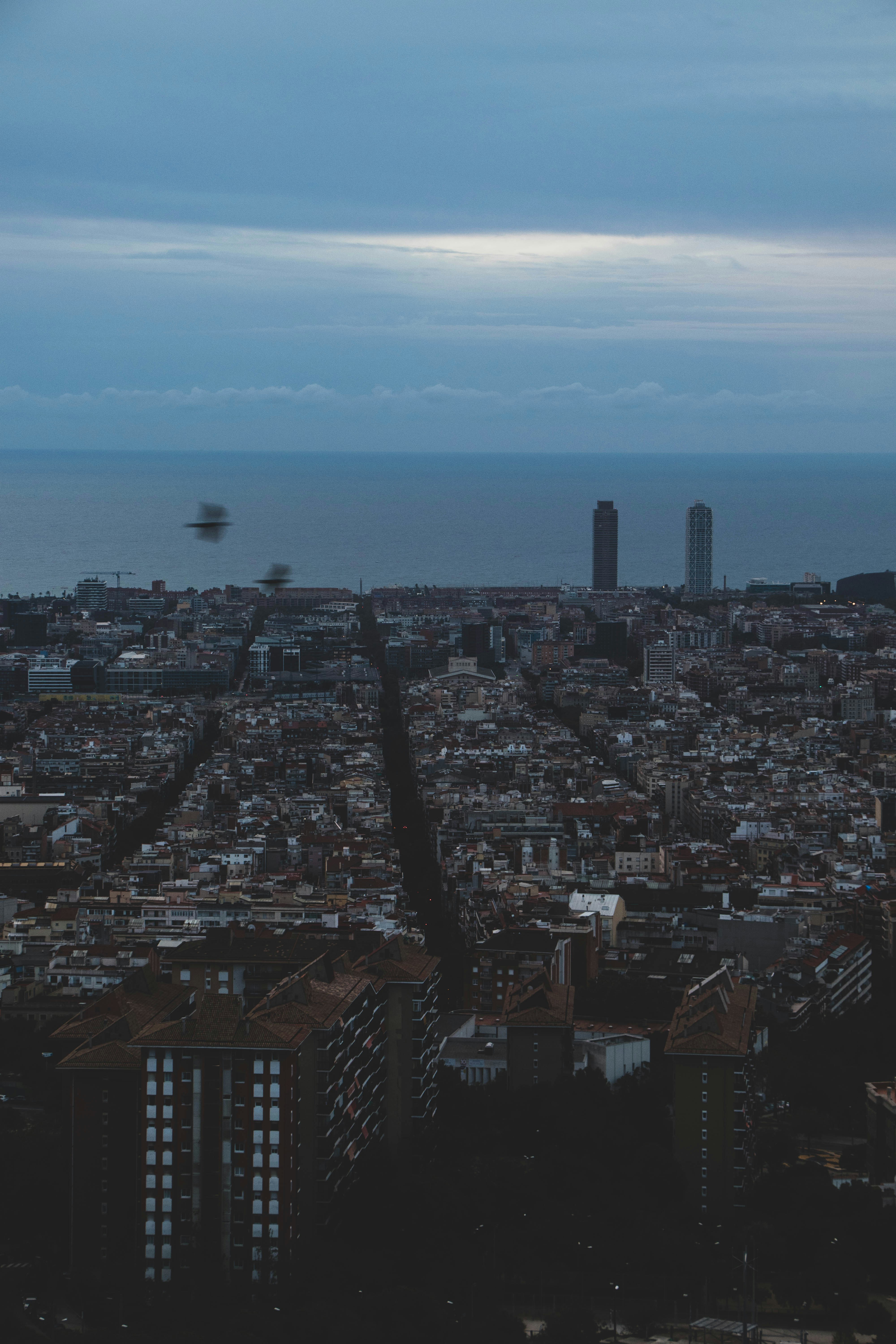 a city with a body of water in the background