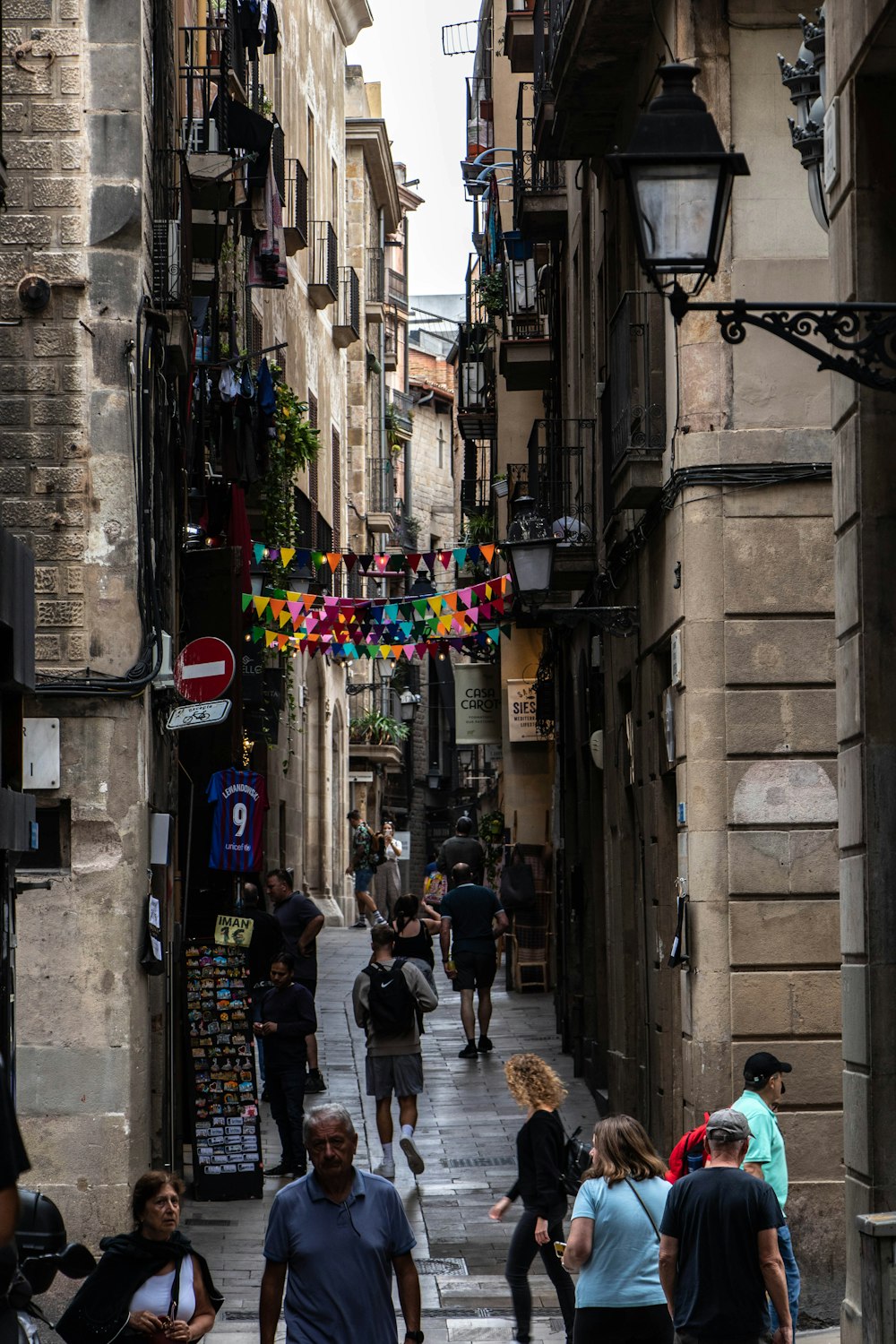 people walking down a narrow street