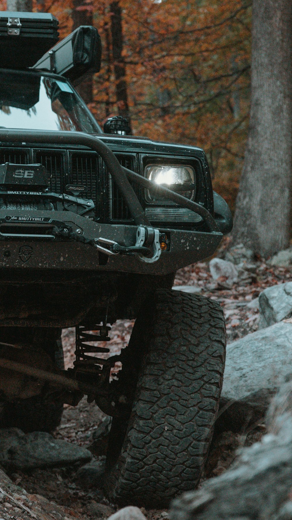 a black jeep with a flat tire