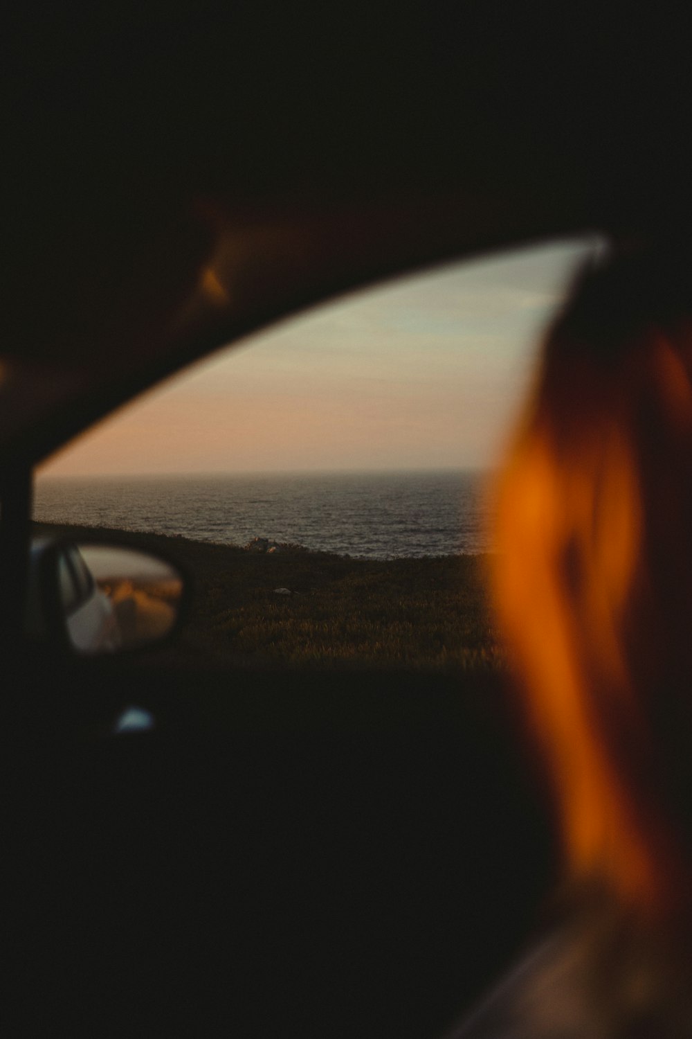 a view of the ocean from inside a car