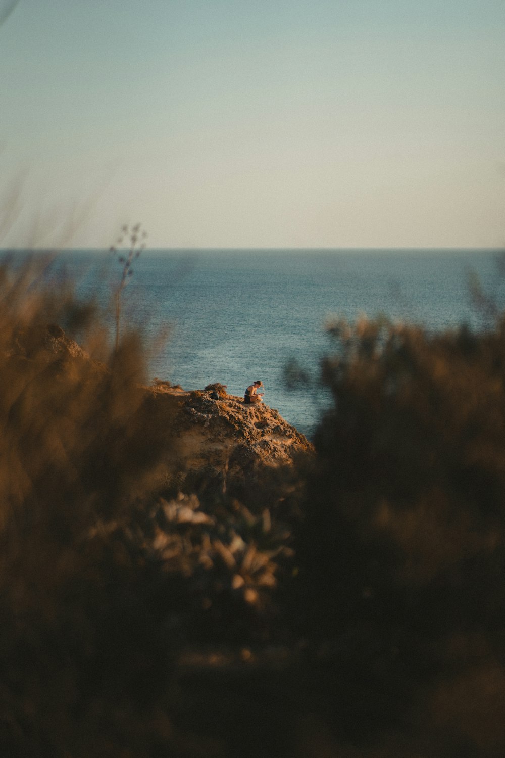 a person sitting on a rock