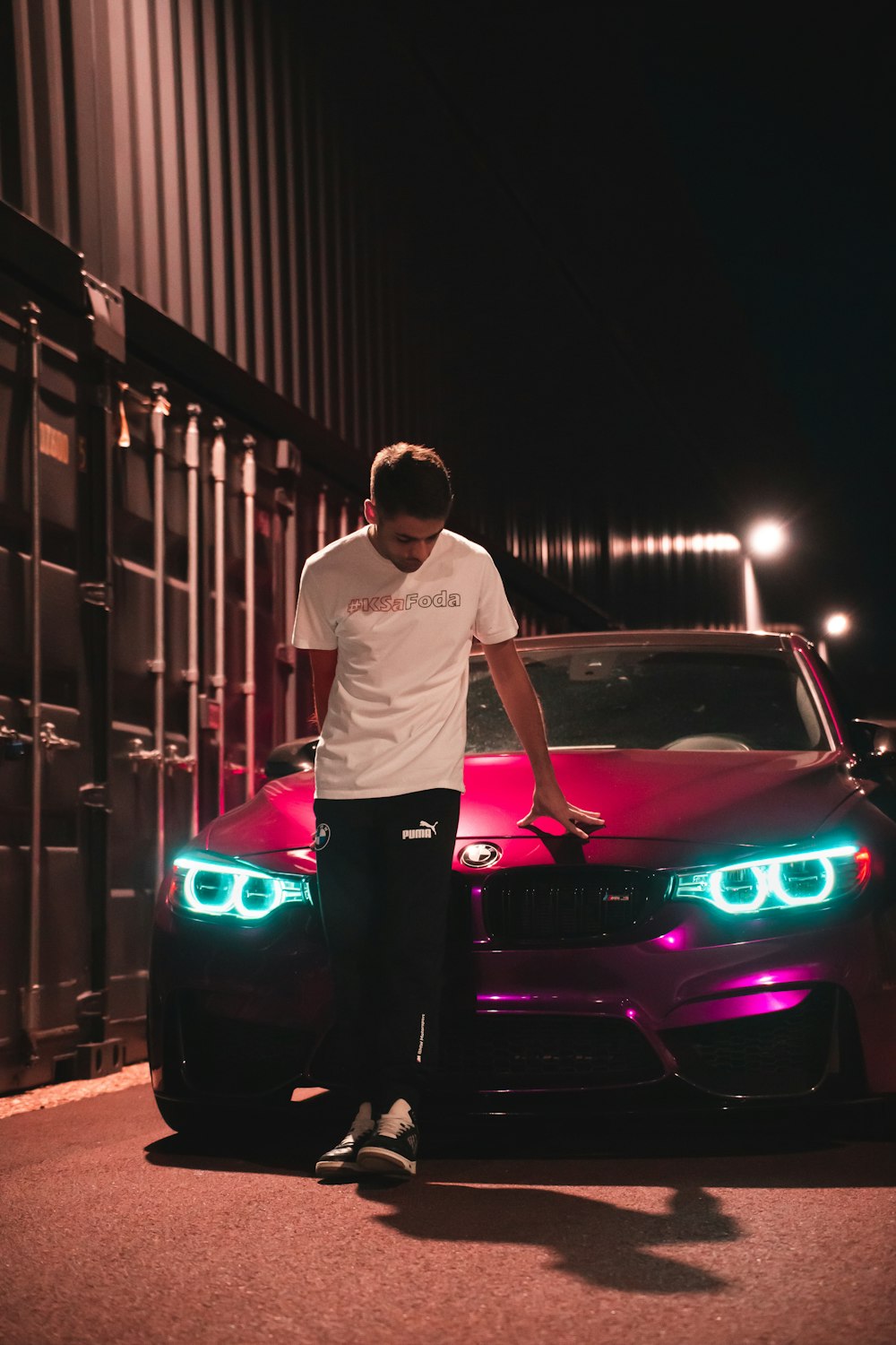 a man standing next to a car