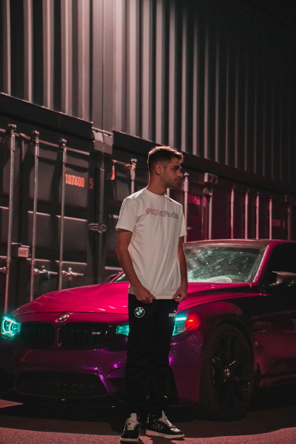 a man standing next to a car