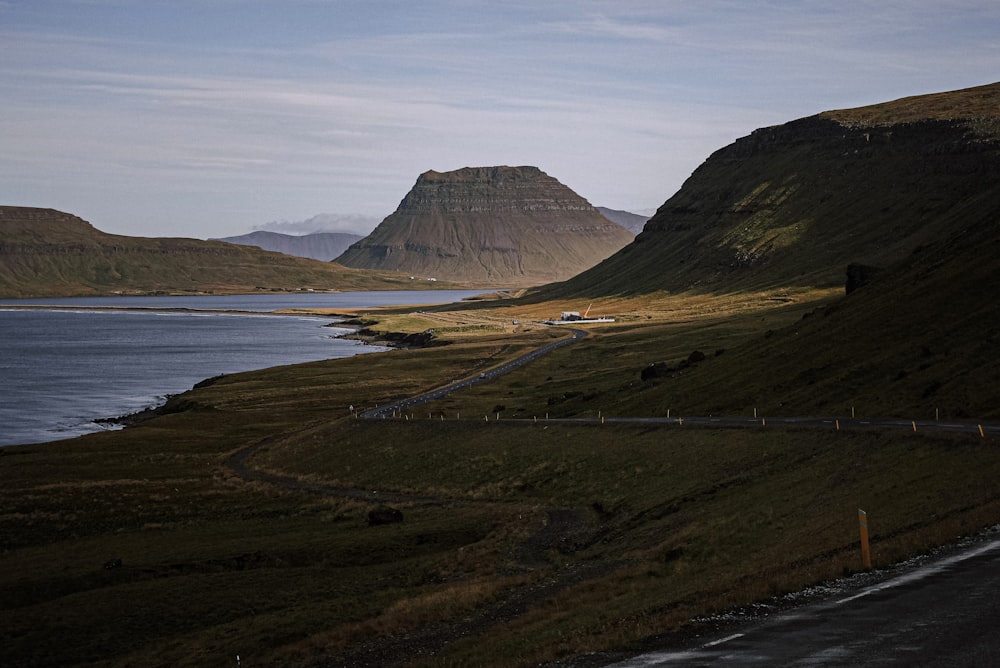 a road next to a body of water