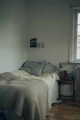 Bright bedroom corner featuring a comfortable bed and minimalist decor.
