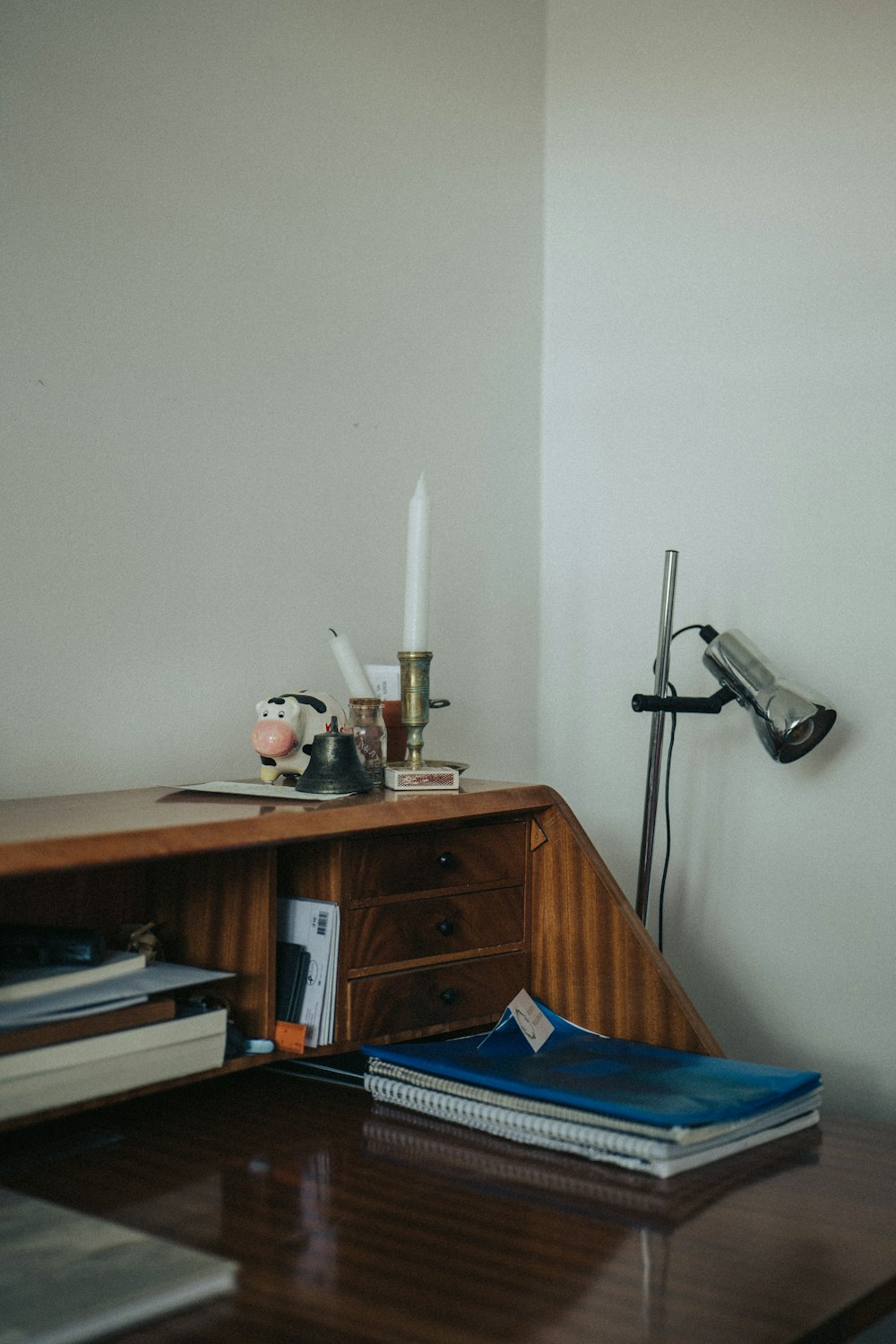 a desk with a lamp and books on it