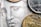 A close-up view of coins placed on a detailed engraving of a face often seen on currency. The coins include various denominations and their metallic surfaces contrast with the intricate line work of the engraved artwork beneath.
