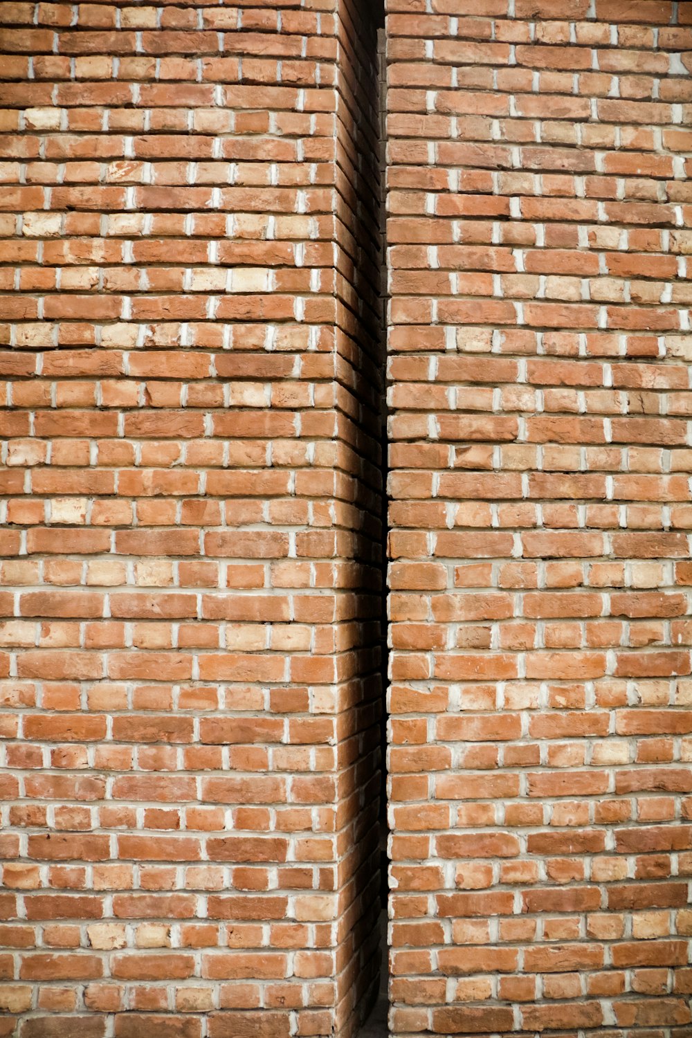 a brick wall with a black grate