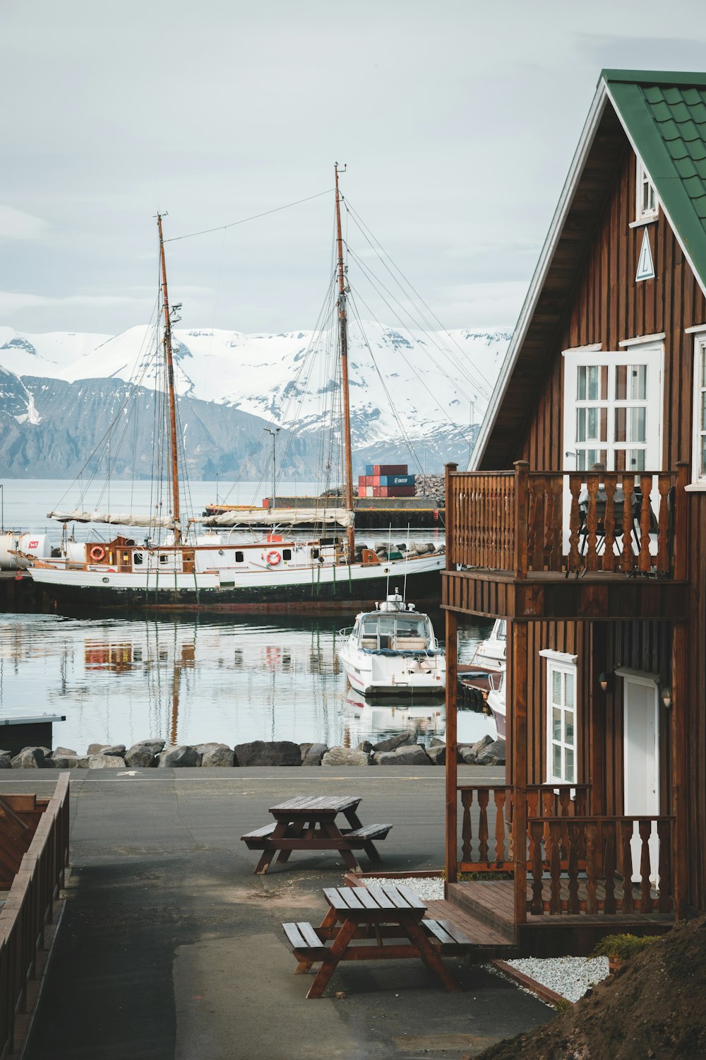 a dock with boats and a mountain in the background