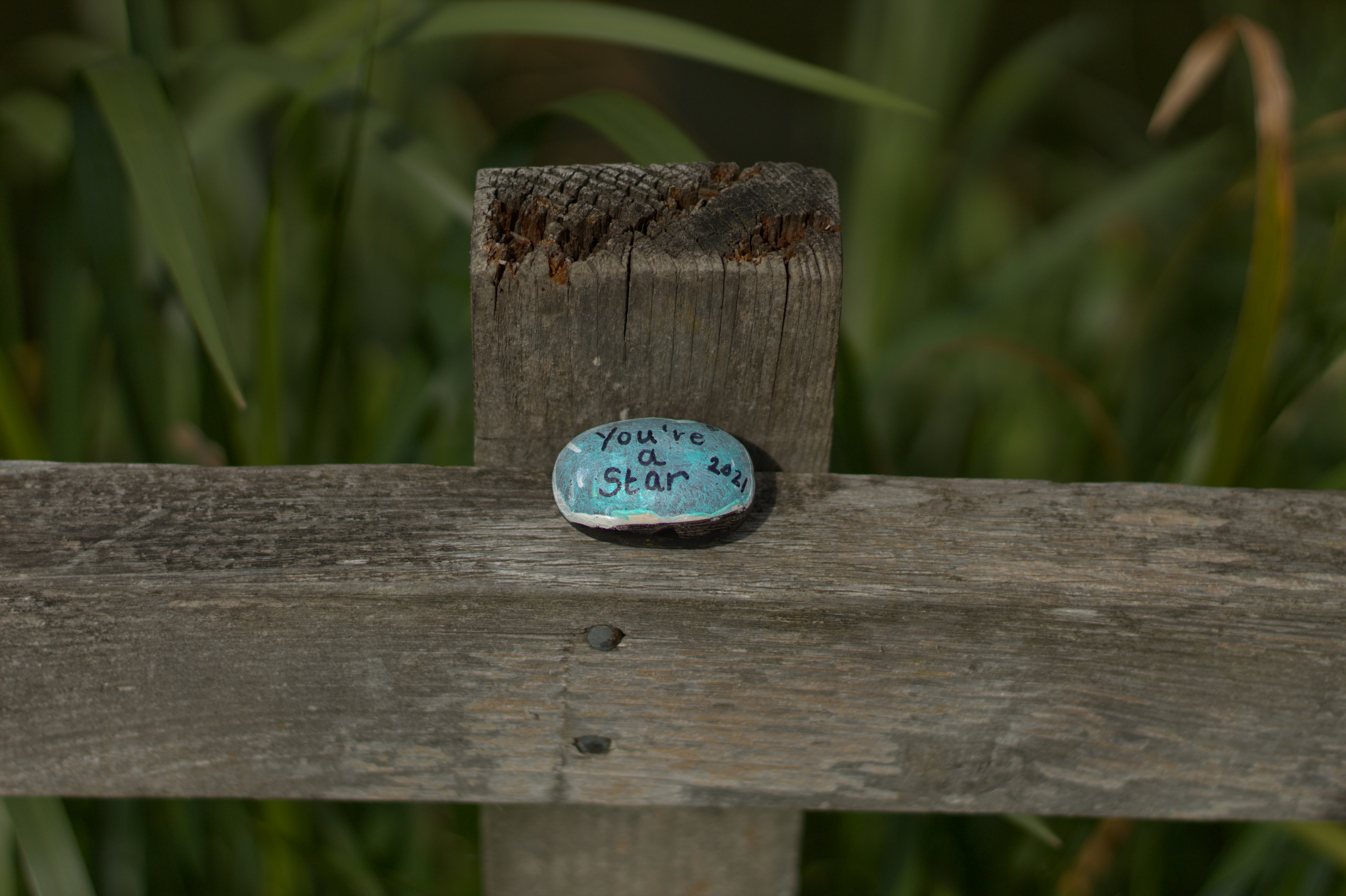 a small wooden watch on a wooden post