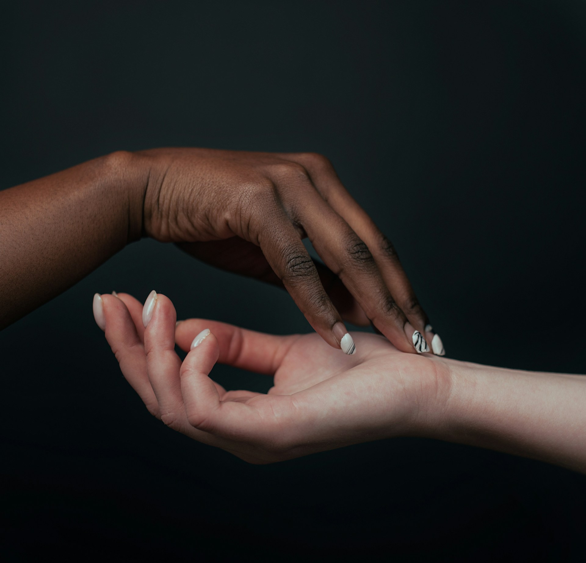 a close-up of hands holding each other