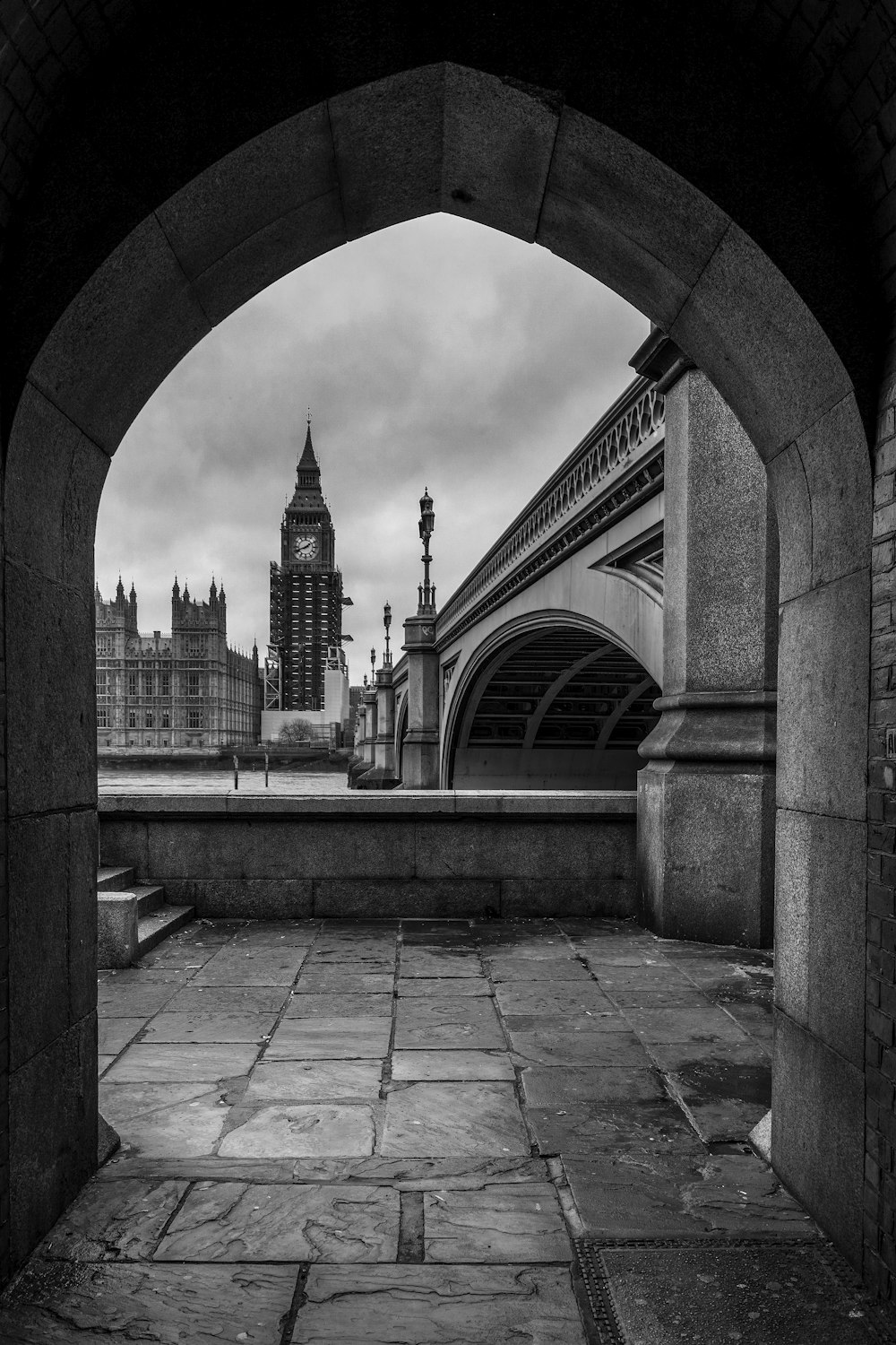 a stone walkway with a clock tower