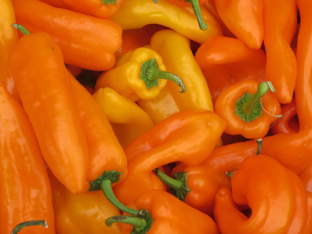 a pile of yellow and red peppers