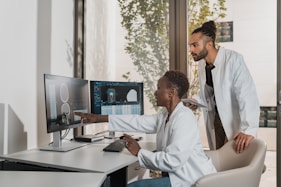 A friendly healthcare professional consulting with employees in a bright, modern onsite clinic.