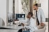 A healthcare professional reviewing medical billing documents in a bright office.