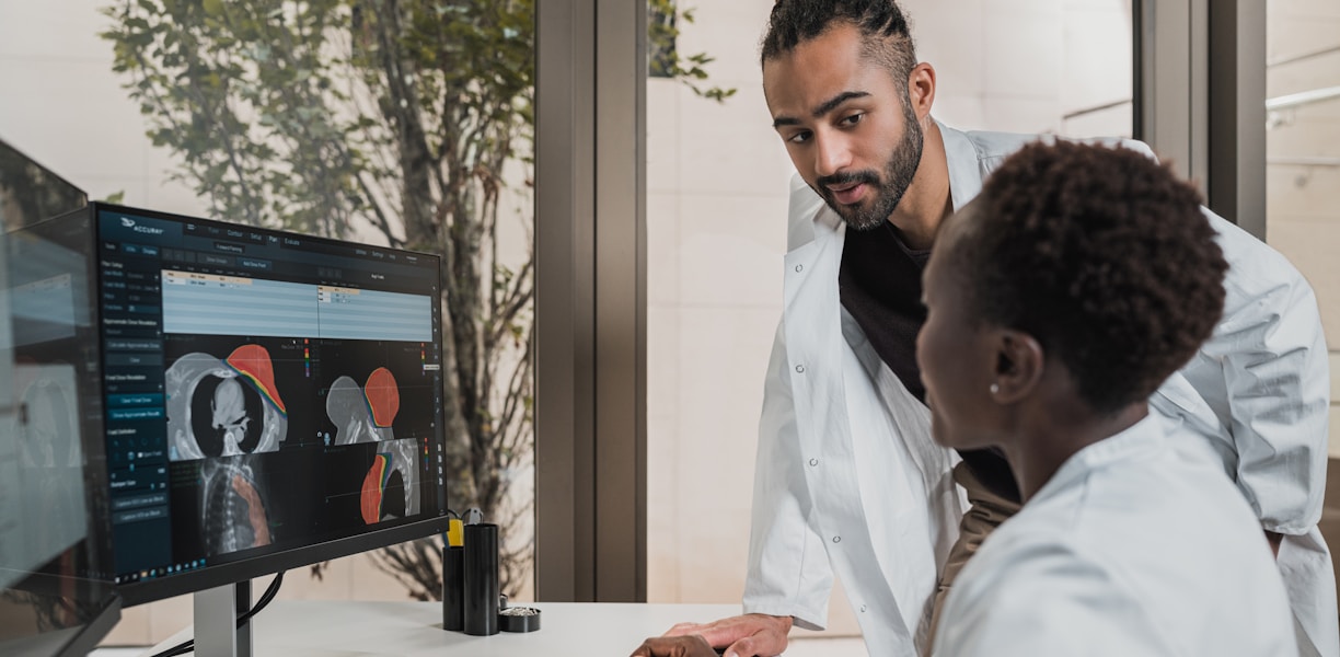 a few men looking at a computer screen