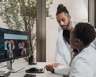 a few men looking at a computer screen