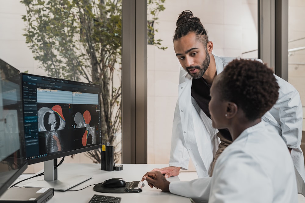 a few men looking at a computer screen