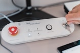 a white rectangular device with a red circle on it