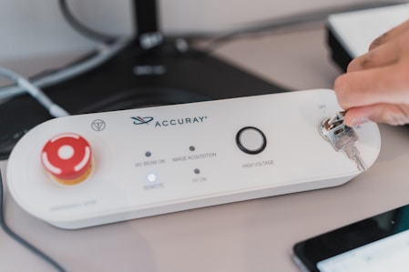 a white rectangular device with a red circle on it