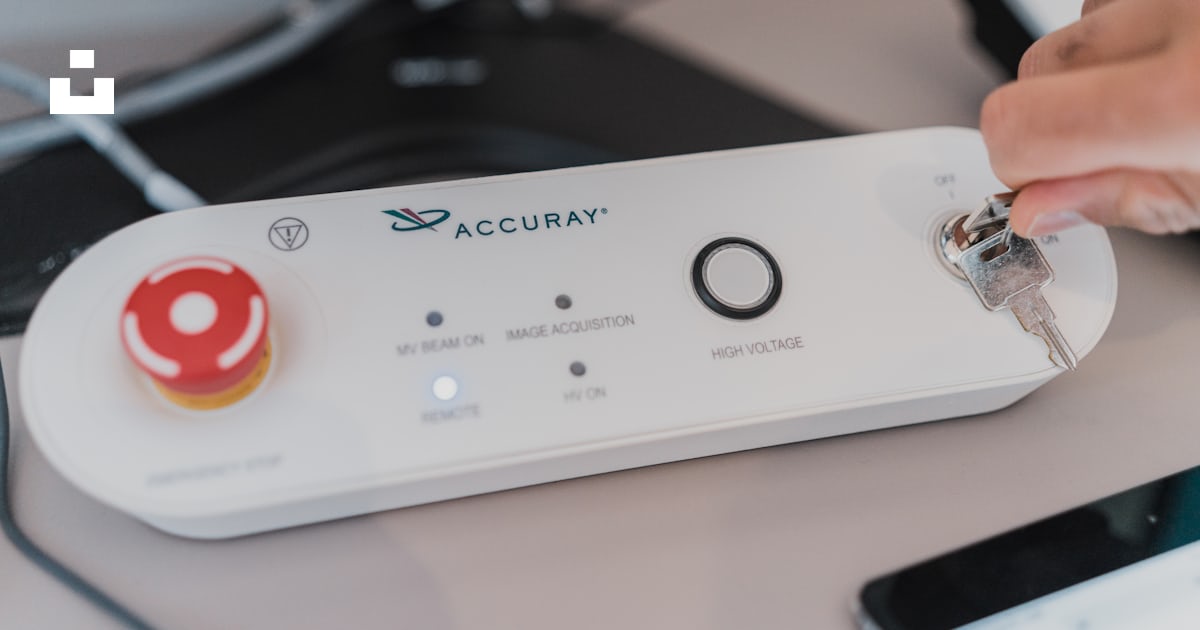 A white rectangular device with a red circle on it photo – Free ...