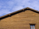 a wooden building with a blue sky