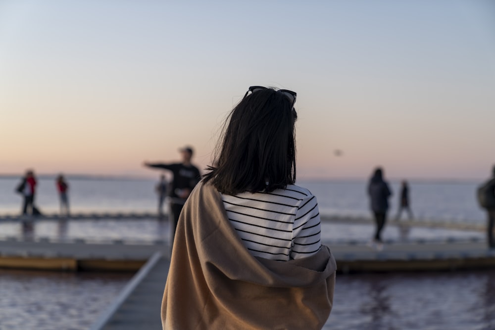 a woman looking at the ocean