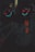 A person wearing a dark hoodie with a glowing, abstract mask featuring bright neon colors, standing in front of a chalkboard. The mask has a sinister smile and crosses for eyes, glowing in red and blue hues. The atmosphere is dark and mysterious.