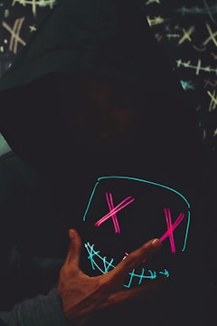 Vibrant neon-lit product shot of a viral hoodie glowing against a dark background.