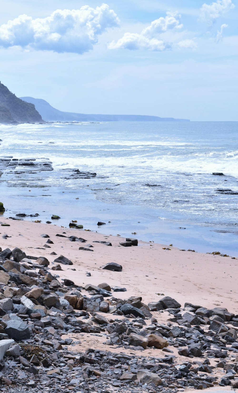 a rocky beach with waves crashing