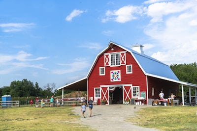 a red barn with people standing in front of it