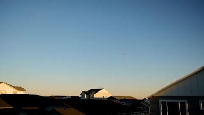 a plane flying over houses