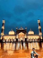 The illuminated Imam Hussain Shrine glowing warmly against the evening sky.