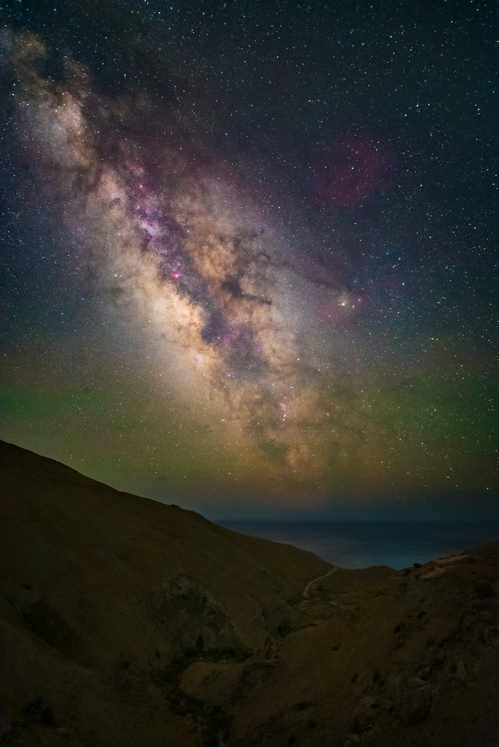 a mountain with a starry sky above it