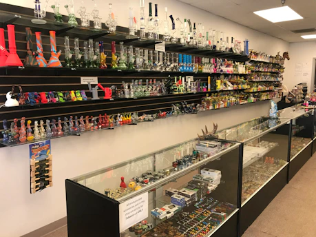 Shelves filled with various smoking accessories and tobacco products in a cozy shop.