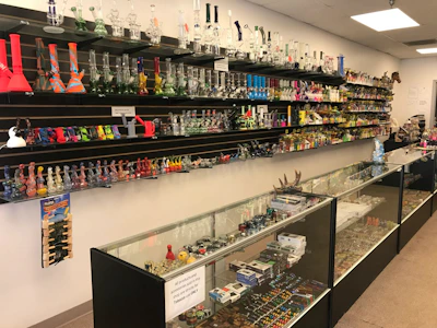 Cozy interior of a well-organized tobacco shop with wooden shelves filled with various tobacco products.