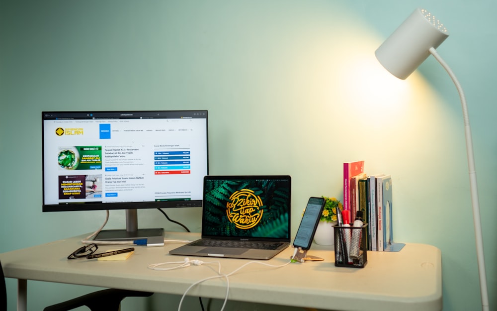 a laptop and a desktop computer on a desk