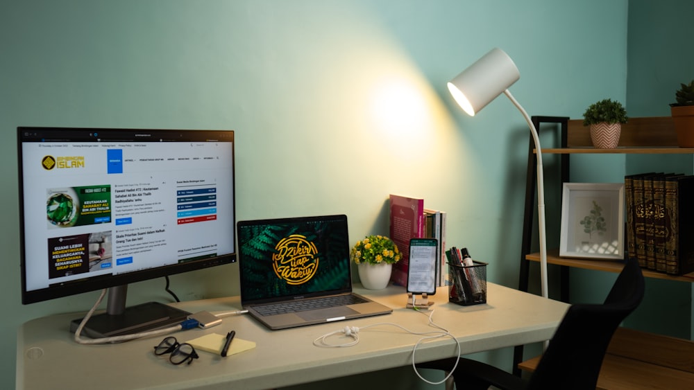 a laptop and a monitor on a desk