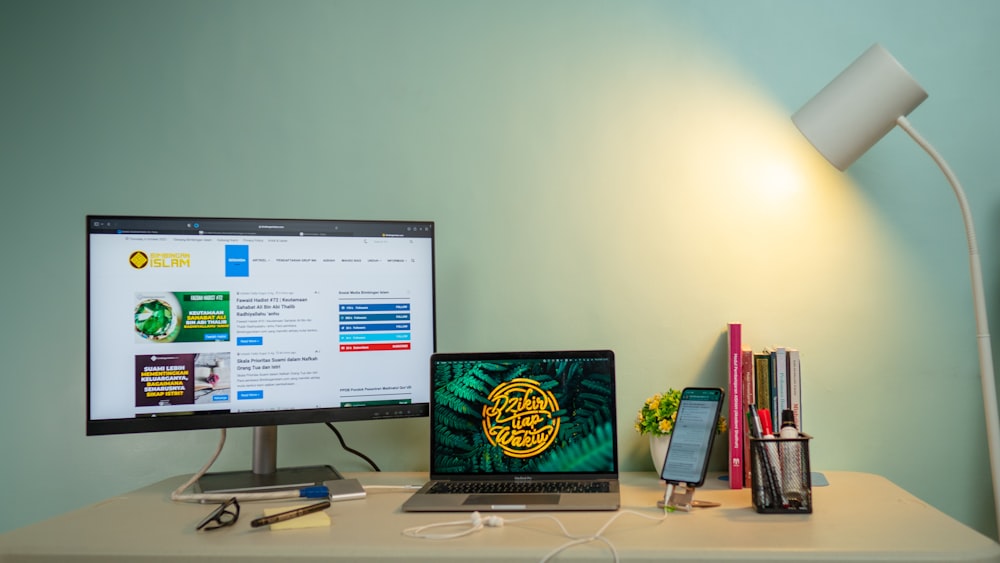 a desk with a laptop and a lamp