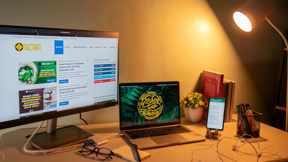 a laptop and a monitor on a desk