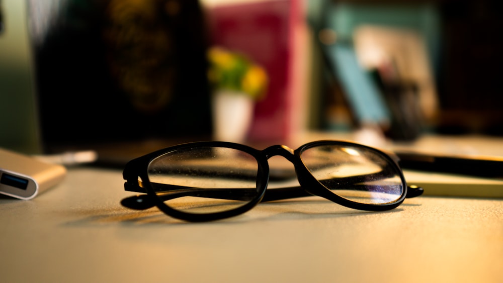 a pair of black glasses on a table