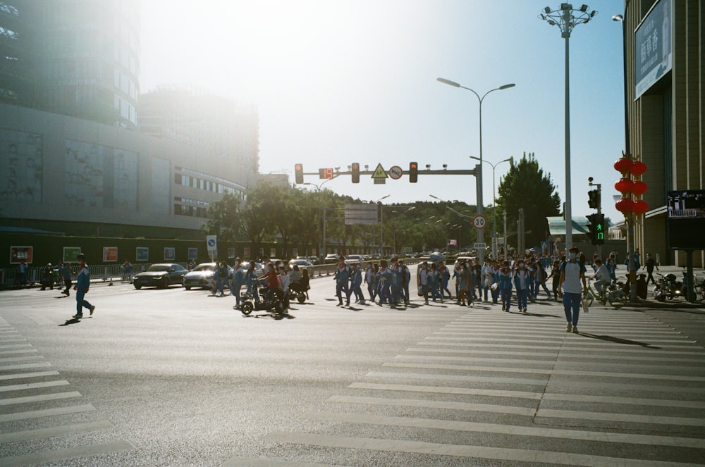 a crowd of people crossing a street