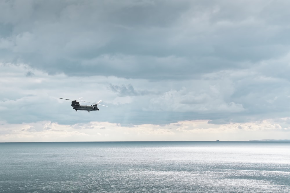 a helicopter flying over a body of water