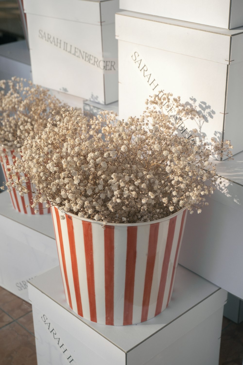 a white and red flower pot