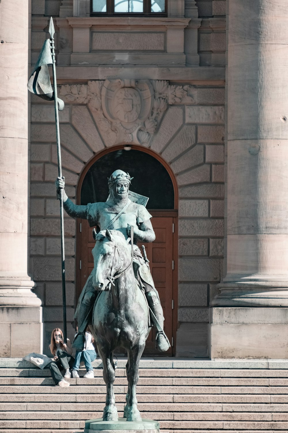 a statue of a person holding a flag