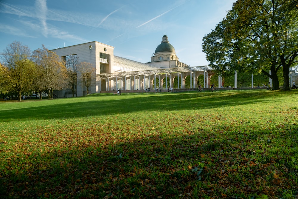 a large building with a green lawn