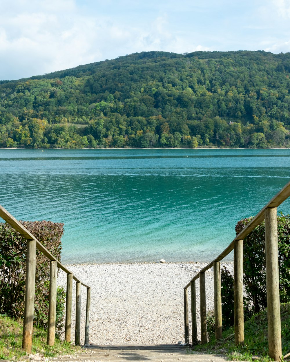 a body of water with a hill in the background